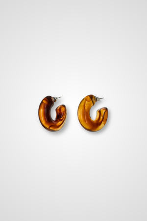 A pair of hoop earrings in a translucent brown with a marble pattern. Chunky design in plastic