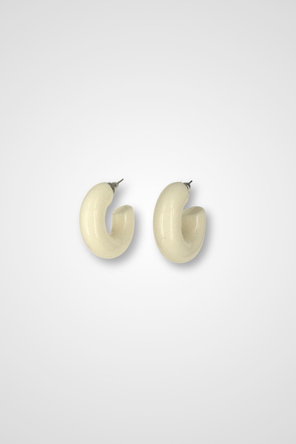 A pair of hoop earrings, white in color and Chunky design in plastic