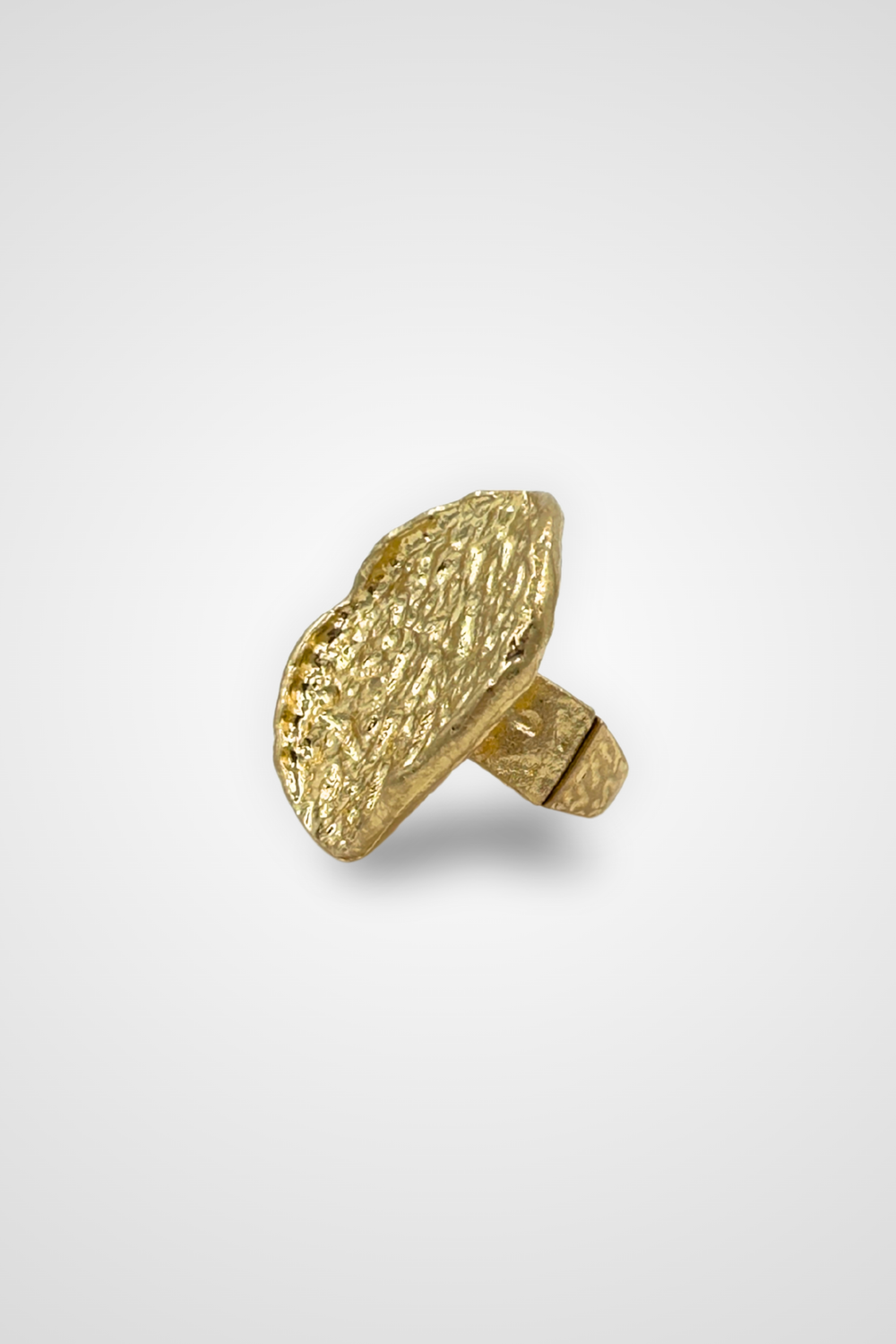 A gold colored ring with a top that looks like a coin