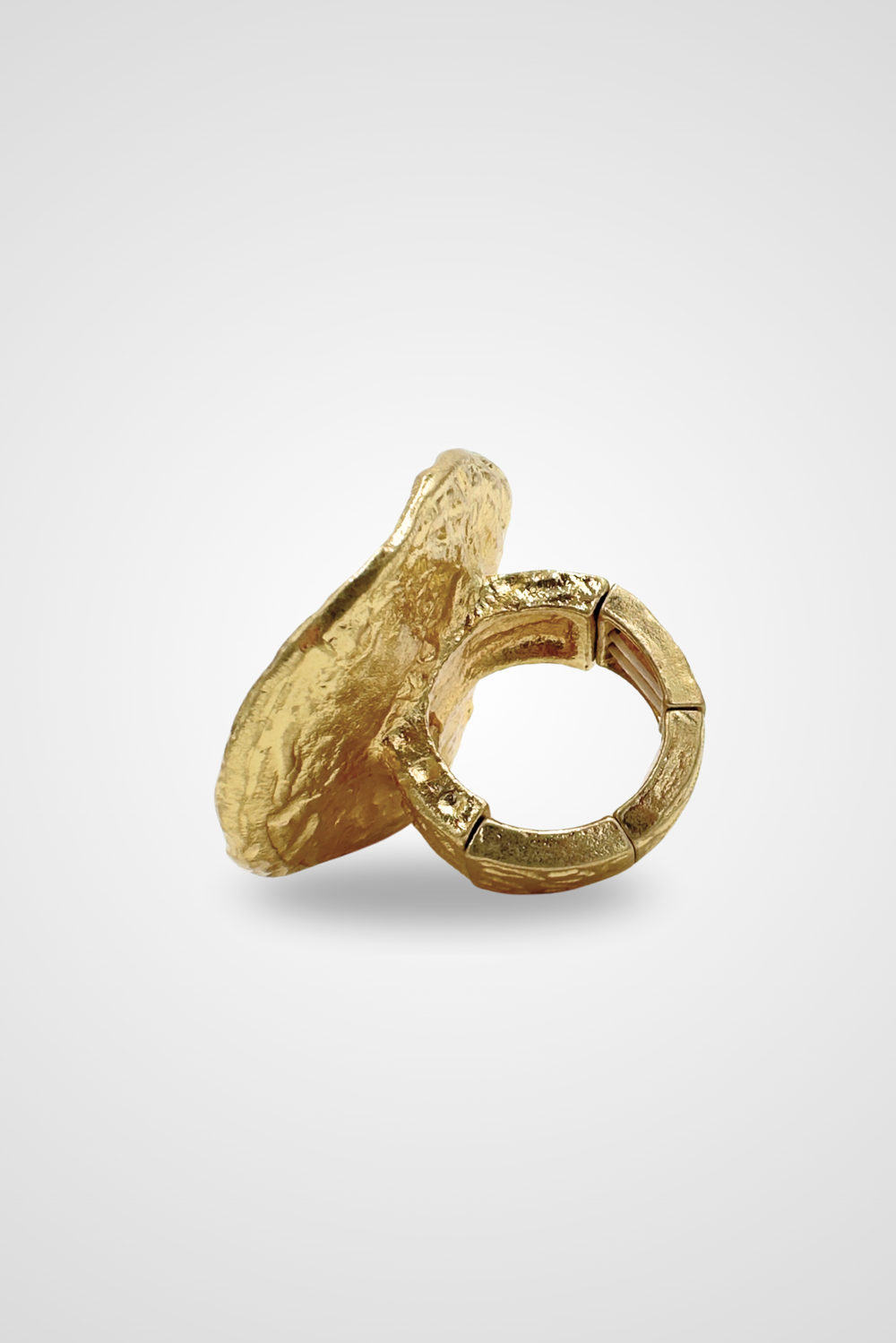 A gold colored ring with a top that looks like a coin