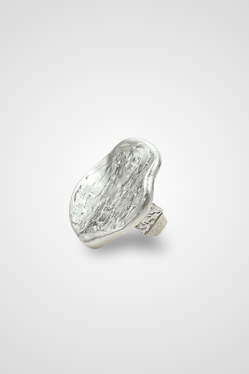 A silver colored ring with a top that looks like a coin