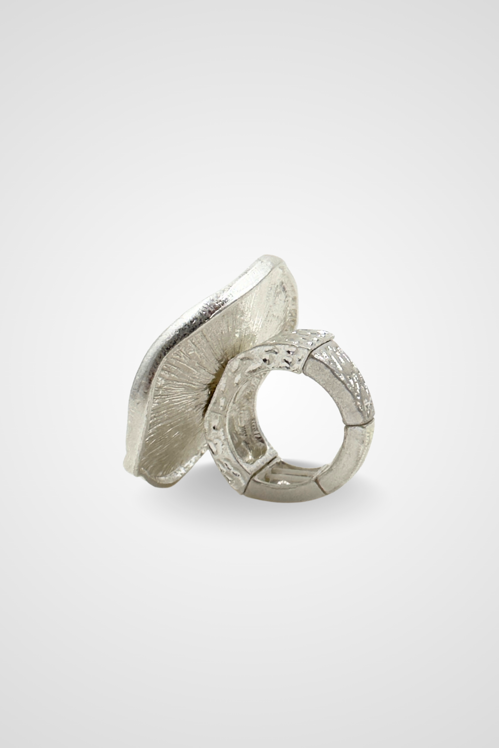 A silver colored ring with a top that looks like a coin